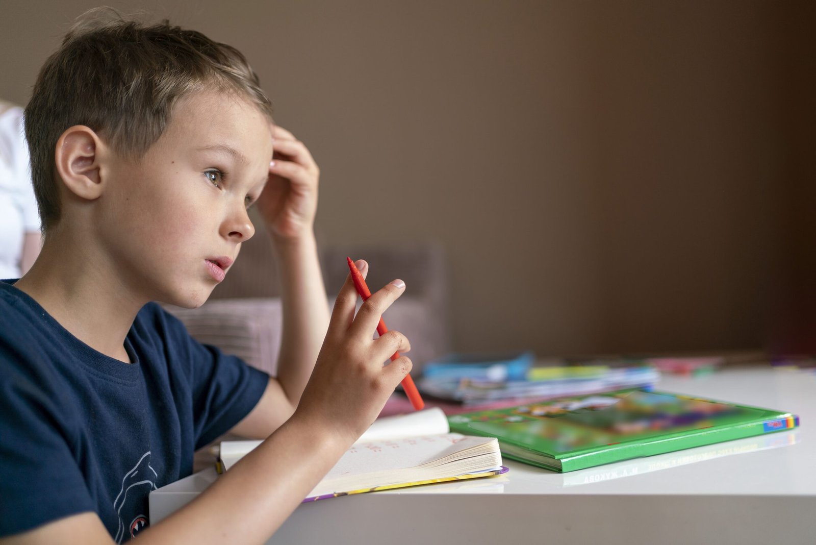 child-boy-with-dark-hair-studies-home-child-doing-homework-min